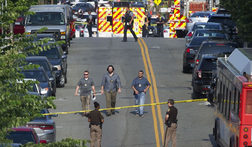 Police and emergency personnel are seen near the scene where House Majority Whip Steve Scalise of La. was shot during a Congressional baseball practice in Alexandria, Va., Wednesday, June 14, 2017. (AP Photo/Cliff Owen)