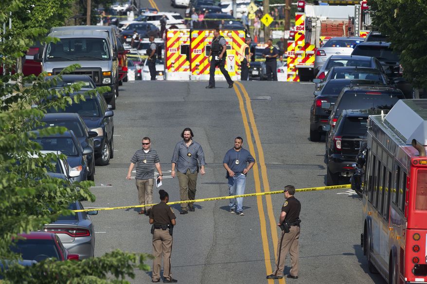 Police and emergency personnel are seen near the scene where House Majority Whip Steve Scalise of La. was shot during a Congressional baseball practice in Alexandria, Va., Wednesday, June 14, 2017. (AP Photo/Cliff Owen)