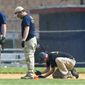 A FBI Evidence Response Team marks evidence on the ball field which is the scene of a multiple shooting in Alexandria, Va., Wednesday, June 14, 2017, after a rifle-wielding attacker opened fire on Republican lawmakers at a congressional baseball practice, wounding House GOP Whip Steve Scalise of Louisiana and several others as congressmen and aides dove for cover.  (AP Photo/Cliff Owen)