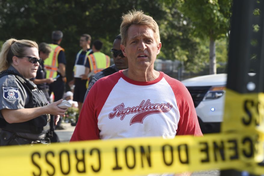 Sen. Jeff Flake, R-Ariz., walks toward media gathered at the scene of a shooting at a baseball field in Alexandria, Va., Wednesday, June 14, 2017, during a Congressional baseball practice where House Majority Whip Steve Scalise of La. was shot. (AP Photo/Kevin S. Vineys)