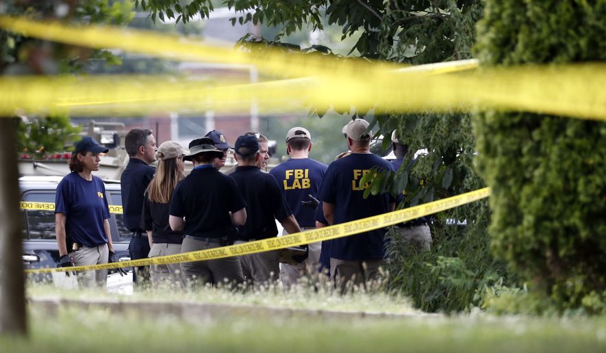 Investigators confer before looking for evidence around the baseball field in Alexandria, Va., Wednesday, June 14, 2017, that was the scene of a shooting  involving House Majority Whip Steve Scalise of La., and others, during Congressional baseball practice. (AP Photo/Alex Brandon)