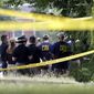 Investigators confer before looking for evidence around the baseball field in Alexandria, Va., Wednesday, June 14, 2017, that was the scene of a shooting  involving House Majority Whip Steve Scalise of La., and others, during Congressional baseball practice. (AP Photo/Alex Brandon)