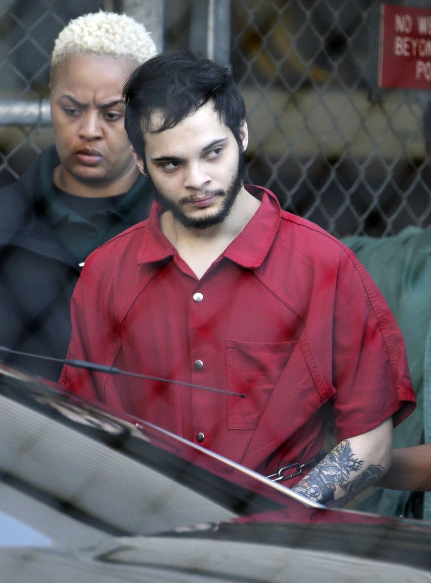 FILE- In this Jan. 30, 2017 file photo, Esteban Santiago is led from the Broward County jail for an arraignment in federal court in Fort Lauderdale, Fla. The Alaska man accused of killing five people at a Florida airport is scheduled for a Wednesday, June 14, 2017, court hearing in Anchorage in an earlier domestic violence case. Santiago had agreed to take part in a deferred sentence program that including completing an anger management course in connection with the 2016 incident. (AP Photo/Lynne Sladky, File)