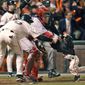 FILE - In this Oct. 24, 2002, file photo, San Francisco Giants&#39; J.T. Snow, left, drags 3-year-old Darren Baker, son of then-Giants manager Dusty Baker, away from home plate and the path of oncoming baserunner David Bell, after Snow scored in the seventh inning of Game 5 of baseball&#39;s World Series in San Francisco. Darren Baker got scooped up by his father&#39;s team again. The son of Washington manager Dusty Baker was drafted by the Nationals in the 27th round of the Major League Baseball draft Wednesday, June 14--15 years after he first headlines on the baseball diamond. (AP Photo/Kevork Djansezian, File)