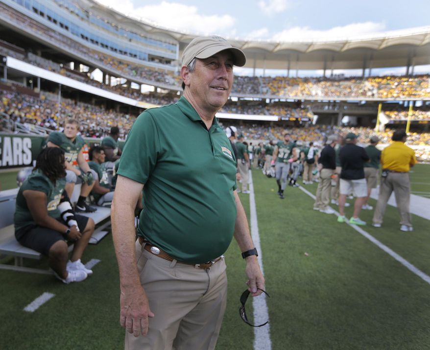 ADVANCE FOR USE MONDAY, JUNE 19 - In this Dec. 3, 2016 photo, Baylor athletic trainer Mike Sims looks during an NCAA football game in Waco, Texas. When Sims arrived at Baylor as a student in 1975, the football team was coming off its "Miracle on the Brazos" Southwest Conference championship season the previous fall. Baylor will lose one of its longest tenured employees in the history of the school when Sims, at 59, leaves on June 23. He worked at 476 consecutive Baylor football games under eight head coaches. (Rod Aydelotte/Waco Tribune-Herald via AP)