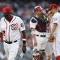 Washington Nationals manager Dusty Baker (12) walks off the field after pulling relief pitcher Blake Treinen and putting in relief pitcher Joe Blanton during the eight inning of a baseball game against the Atlanta Braves at Nationals Park, Wednesday, June 14, 2017, in Washington. The Braves won 13-2. Behind Baker, catcher Jose Lobaton (59) talks with relief pitcher Joe Blanton (56) on the mound.(AP Photo/Carolyn Kaster)