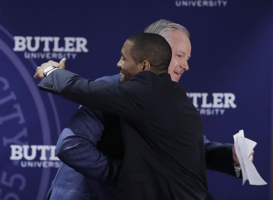Butler athletic director Barry Collier, left, congratulates LaVall Jordan during an NCAA college basketball news conference introducing Jordan as the new men's head basketball coach at Butler, Wednesday, June 14, 2017, in Indianapolis. (AP Photo/Darron Cummings)