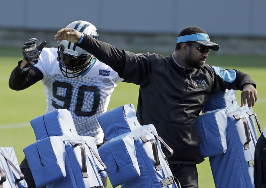 Carolina Panthers&#39; Julius Peppers (90) runs a drill with assistant defensive line coach Sam Mills III, right, during the NFL football team&#39;s minicamp in Charlotte, N.C., Wednesday, June 14, 2017. (AP Photo/Chuck Burton) ** FILE **