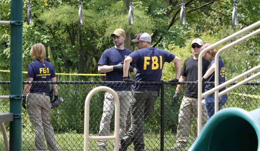 FBI agents investigate a playground near the baseball field in Alexandria, Va., Thursday, June 15, 2017, the day after then-House Majority Whip Steve Scalise of La. was shot during a congressional baseball practice at the park. (AP Photo/Jacquelyn Martin) ** FILE **