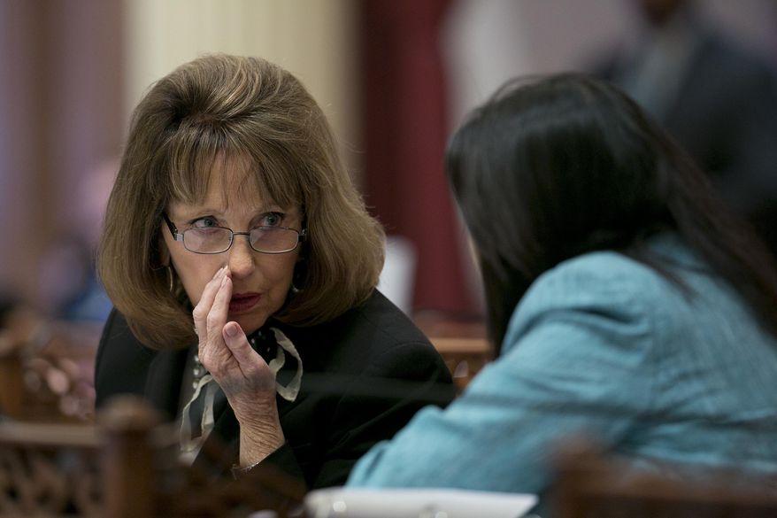 Senate Minority Leader Pat Bates, R-Laguna Niguel, left, huddles with Sen. Janet Nguyen, R-Fountain Valley, as the Senate debates the state budget plan, Thursday, June 15, 2017,in Sacramento, Calif. The Senate approved the $125 billion general fund spending plan, which was negotiated by Democratic Gov. Jerry Brown and Democratic legislative leaders. (AP Photo/Rich Pedroncelli)