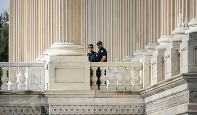 Capitol Hill Police officers stand watch outside the House of Representatives on Capitol Hill in Washington, Thursday, June 15, 2017, a day after a gunman opened fire on a lawmakers playing baseball and wounded House Majority Whip Steve Scalise of La. at a baseball practice in Alexandria, Va. (AP Photo/J. Scott Applewhite)