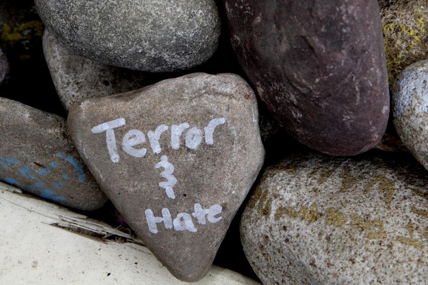 A rock has the words "terror and hate" written on it at an art installation that encourages the public to write out their fears and leave them behind, along Mt. Vernon Ave in Alexandria, Va., Thursday, June 15, 2017, the day after House Majority Whip Steve Scalise of La. was shot during during a congressional baseball practice. (AP Photo/Jacquelyn Martin)