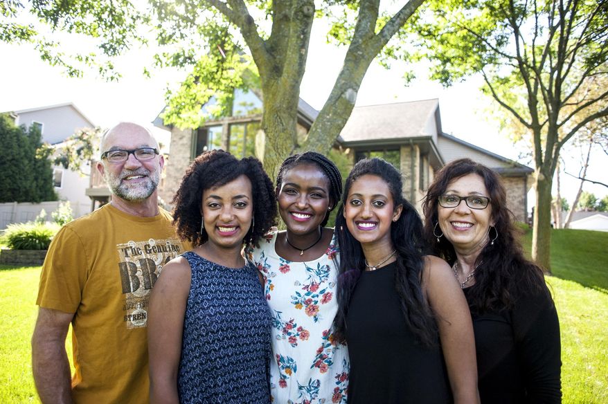 ADVANCE FOR SATURDAY, JUNE 17, 2017 AND THEREAFTER - In this June 7, 2017 photo, from left, Dennis Dregne, Messay Dregne, Jerusalem Dregne, Frehiwot Dregne and Connie Dregne at their home in Janesville, Wis. The three girls were adopted by Dennis and Connie from Ethiopia. (Angela Major/The Janesville Gazette via AP)
