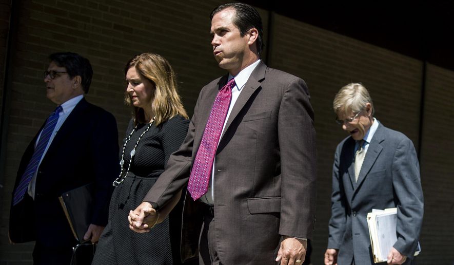 Nick Lyon, Michigan Department of Health and Human Services director, sighs as he walks out of the court house after his release on a cash bond following his arraignment on Thursday, June 15, 2017 at Genesee District Court in downtown Flint. Lyon is charged with misconduct in office for allegedly obstructing university researchers who are studying if the surge in cases was linked to the Flint River. (Jake May/The Flint Journal-MLive.com via AP)