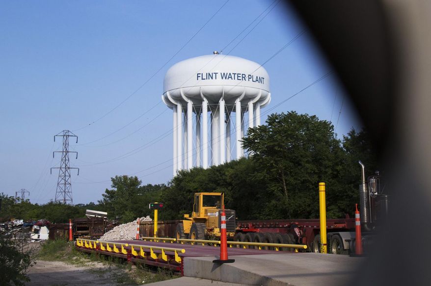 A water tower is seen in Flint, Mich., Wednesday, June 14, 2017. Five people, including the head of Michigan&#39;s health department, were charged Wednesday with involuntary manslaughter in an investigation of Flint&#39;s lead-contaminated water, all blamed in the death of an 85-year-old man who had Legionnaires&#39; disease. (Shannon Millard/The Flint Journal-MLive.com via AP)