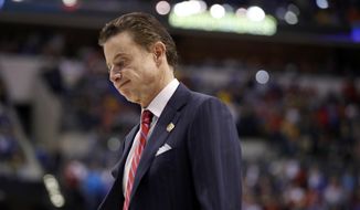 FILE - In this March 19, 2017, file photo, Louisville head coach Rick Pitino walks off the court after a 73-69 loss to Michigan in a second-round game in the men&#x27;s NCAA college basketball tournament in Indianapolis. Louisville and coach Pitino are awaiting discipline from the NCAA on Thursday, June 15, 2017, regarding a sex scandal that engulfed the men&#x27;s basketball program. A former men&#x27;s basketball staffer is alleged to have hired strippers to entertain players and recruits.  (AP Photo/Jeff Roberson, File)