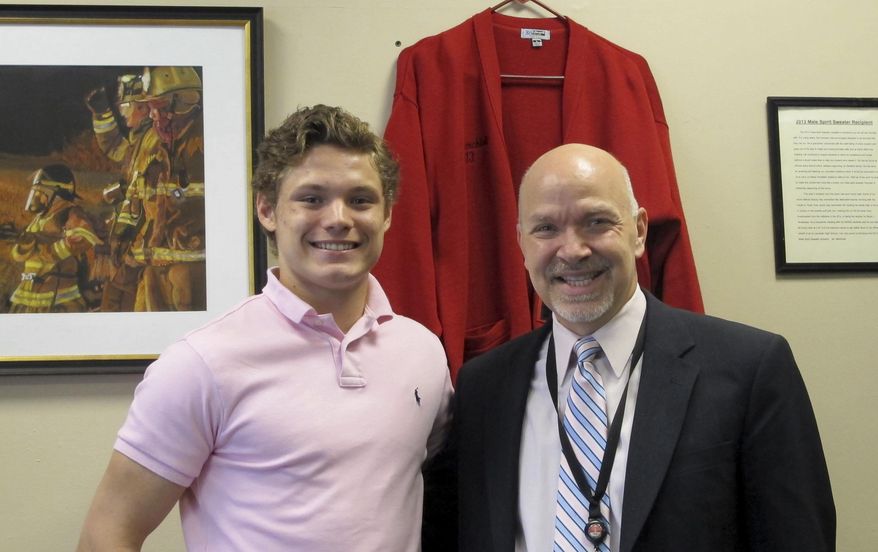 In this June 6, 2017 photo, Connor Carrow, 17, left, and Principal Cesar Marchioli pose inside Marchioli's office at Lancaster, High School in Lancaster, N.Y., the day after Marchioli gave Carrow a leadership award at the senior awards banquet. Carrow has been leading efforts at the school to replace the traditional class ranking system with a Latin honors cum laude system that recognizes all students who achieve a certain academic threshold. The ranking of students from No. 1 on down, based on grade point averages, has been fading steadily for about the past decade and about half of American schools no longer report class rank. (AP Photo/Carolyn Thompson)