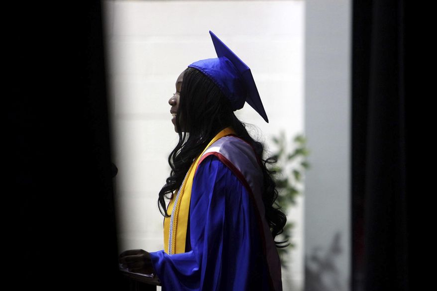 FILE - In this June 14, 2014 file photo, Carmen Stringfield introduces the valedictorian at their commencement ceremony at Pender High School in Burgaw, N.C. In a movement that has gathered steam over about the past decade, schools around the country have stopped numbering students from valedictorian on down. Instead, they've adopted honors that recognize everyone who scores at a certain threshold - by having multiple valedictorians, for example, or awarding college-style cum laude honors. (Jason A. Frizzelle /The Star-News via AP)