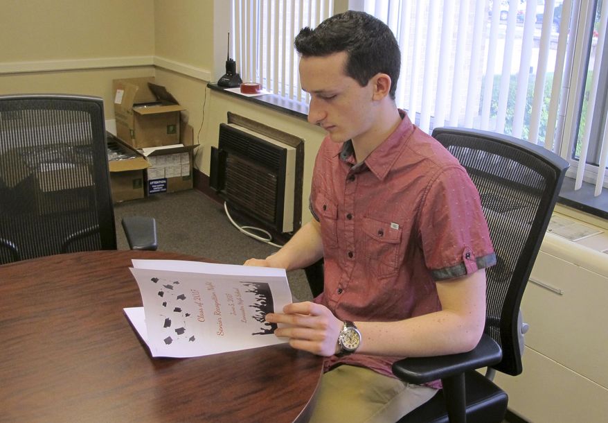 In this June 6, 2017 photo, Daniel Buscaglia, 17, looks through the program from the previous night's senior awards banquet at Lancaster High School in Lancaster, N.Y. Buscaglia's 101.9 grade point average earned him the honor of valedictorian of his graduating class of nearly 500 students, but at many American high schools, the tradition of ranking students from No. 1 on down is being replaced by honors that recognize everyone who scores at a certain threshold. (AP Photo/Carolyn Thompson)
