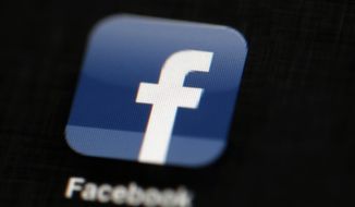 The Facebook logo is displayed on an iPad in Philadelphia on May 16, 2012. (Associated Press) **FILE**