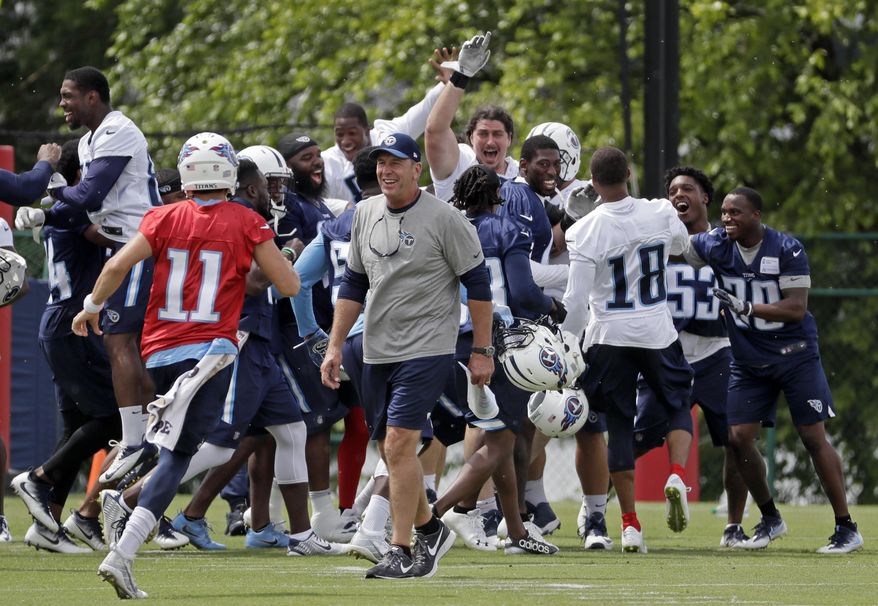 Tennessee Titans head coach Mike Mularkey walks off the field as players celebrate after beating the coaches in a high-speed punt, pass and kick competition during NFL football minicamp Thursday, June 15, 2017, in Nashville, Tenn. Since the players won, they earned a pass from the final practice of their three-day minicamp and wrapped up the offseason program a bit early. (AP Photo/Mark Humphrey)