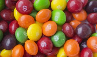 This June 1, 2016, file photo shows Skittles in New York. Skittles has temporarily ditched its rainbow theme in favor of an all-white look in the United Kingdom and Germany in order to celebrate LGBT pride. (AP Photo/Mark Lennihan, File)