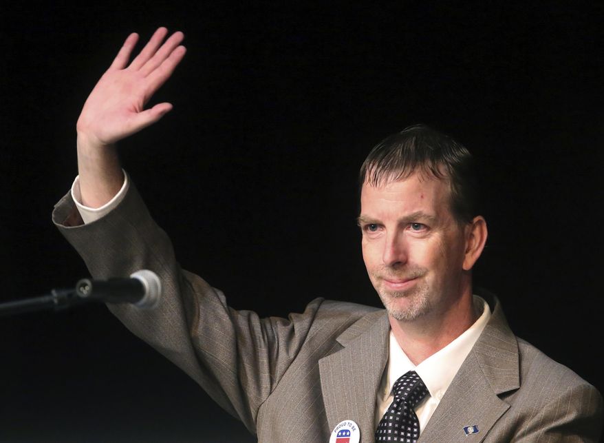 Shayne Row waves during a debate at Mountain View High School on Friday, June 16, 2017, in Orem, Utah, on the eve of a Utah GOP convention where delegates will winnow the crowded field. (AP Photo/Rick Bowmer)