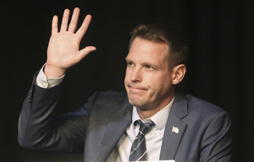 American Fork lawyer Damian Kidd waves during a debate at Mountain View High School Friday, June 16, 2017, in Orem, Utah. At least 10 Republicans running to replace U.S. Rep. Jason Chaffetz are expected to face off in two debates Friday night, the eve of a Utah GOP convention where delegates will winnow the crowded field. (AP Photo/Rick Bowmer)