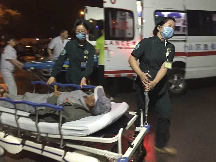 In this photo released by China's Xinhua News Agency, medical workers transport a person injured in an explosion outside a kindergarten into a hospital in Fengxian County in eastern China's Jiangsu Province early Friday, June 16, 2017. Several people were killed and dozens more injured in an explosion Thursday at the front gate of the kindergarten in eastern China as relatives were picking up their children at the end of the school day, local officials said. (Li Xiang/Xinhua via AP)