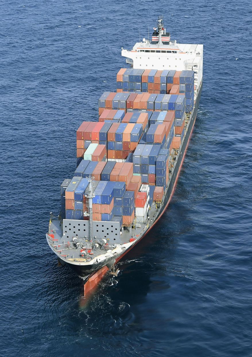 CORRECTS DATE - The Philippine-registered container ship ACX Crystal is seen off Izu Oshima, Japan, after it collided with the USS Fitzgerald southwest of Yokusuka, Japan, Saturday, June 17, 2017. The U.S. Navy says the USS Fitzgerald suffered damage below the water line on its starboard side after it collided with the Philippine-flagged merchant ship. (Iori Sagisawa/Kyodo News via AP)