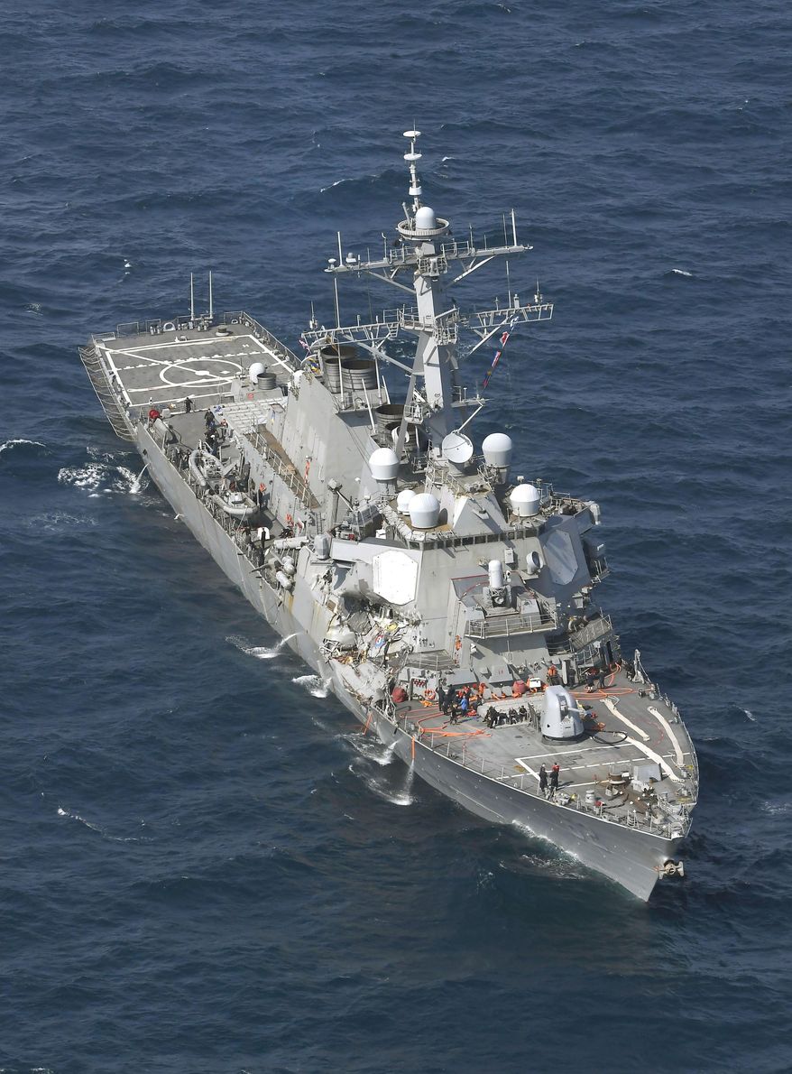CORRECTS DATE - The USS Fitzgerald is seen off Shimoda, Shizuoka prefecture, Japan, after the Navy destroyer collided with a merchant ship, Saturday, June 17, 2017. Seven crew members are missing and one injured after the U.S. Navy destroyer collided early Saturday morning with a merchant ship off the coast of Japan, the country's coast guard reported. (Iori Sagisawa/Kyodo News via AP)