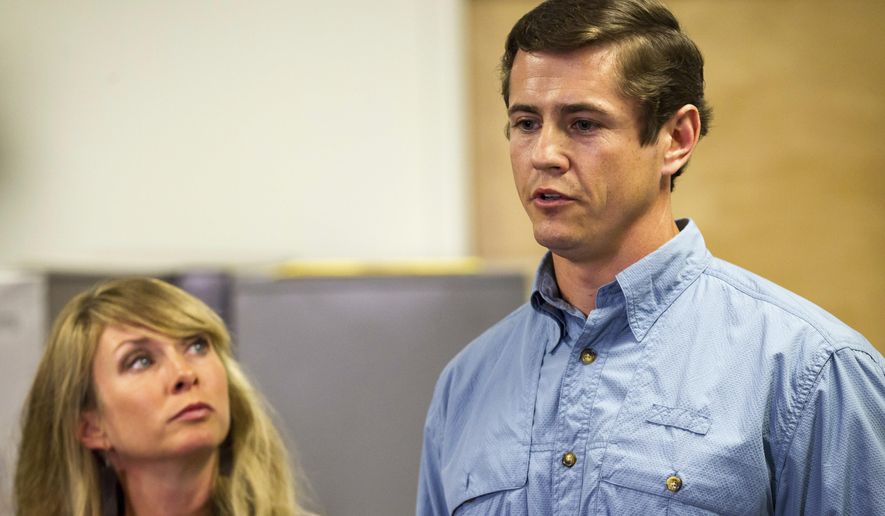 Patrick Hale, the man credited by law enforcement with forcing the surrender of two Georgia prison escapees, speaks to reporters in Murfreesboro, Tenn., on Friday, June 16, 2017, while his wife, Danielle, looks on. Hale said he was carrying a loaded weapon but never pulled it out when the two inmates got face down on his concrete driveway without saying a word. (AP Photo/Erik Schelzig)