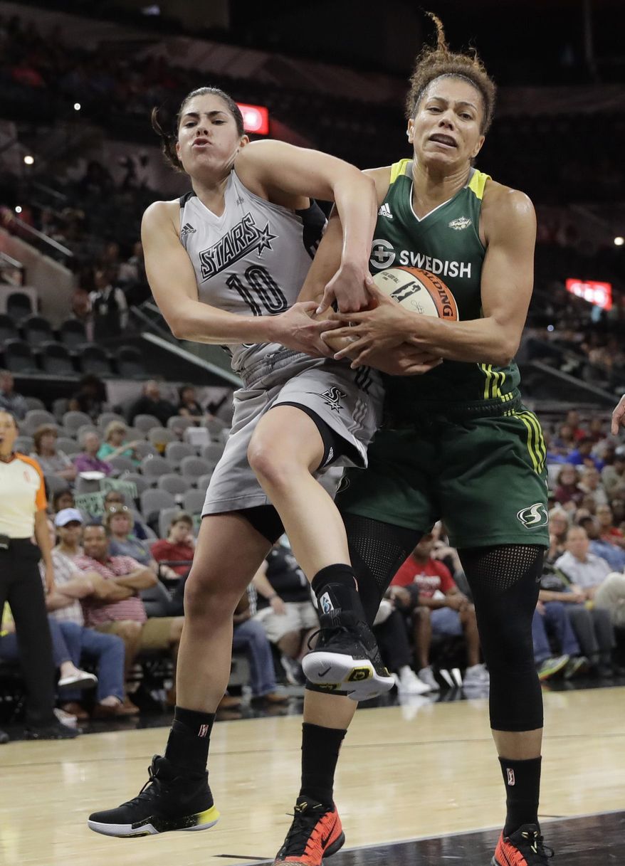 FILE --In this June 6, 2017, file photo, San Antonio Stars guard Kelsey Plum (10) and Seattle Storm forward Alysha Clark (32) battle for a rebound during the second half of a WNBA basketball game in San Antonio. Plum returns to her college hometown of Seattle this weekend when San Antonio faces Seattle on Sunday. It&#39;s a return to the city where Plum developed into the NCAA all-time record holder in scoring at Washington and it will be Plum&#39;s first trip back to Seattle since being drafted No. 1 overall by the Stars. (AP Photo/Eric Gay, File)