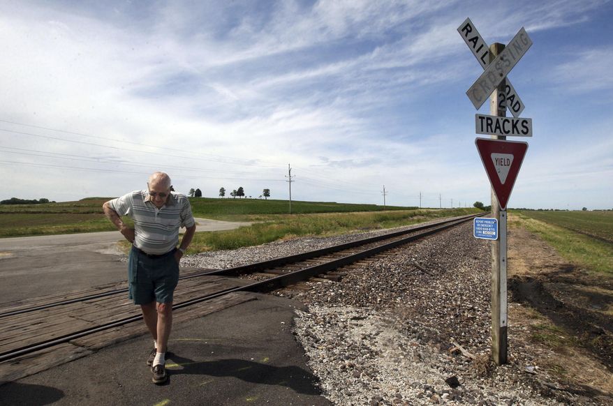Bob Barnes surveys the site of an accident Thursday, June 15, 2017, involving a van and a freight train at a railroad intersection on Christian County Road 1800 East near Nokomis Wednesday evening. The crash killed the van's five occupants including Barnes' friend Mary Pugsley. Barnes came to the scene the day after to find out more about what had happened.(Jim Bowling/Herald & Review via AP)