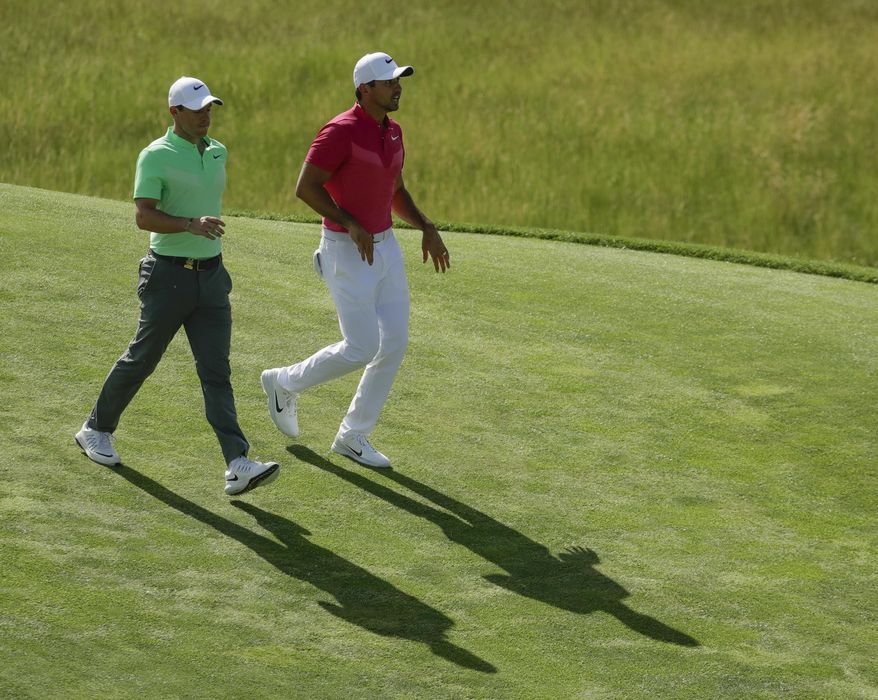 Rory Mcilroy, of Ireland, and Jason Day, of Australia, walk on the eighth hole during the first round of the U.S. Open golf tournament Thursday, June 15, 2017, at Erin Hills in Erin, Wis. (AP Photo/Charlie Riedel)
