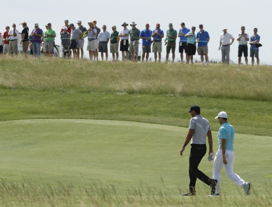 Jason Day, of Australia, and Rory McIlroy, of Ireland, walk up the 18th hole during the second round of the U.S. Open golf tournament Friday, June 16, 2017, at Erin Hills in Erin, Wis. (AP Photo/Charlie Riedel)