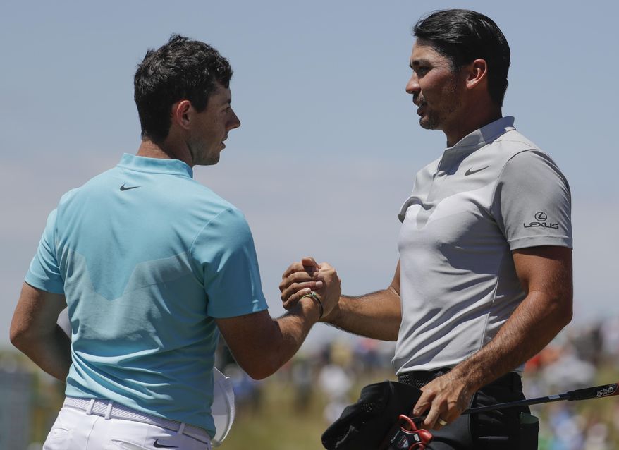 Jason Day, of Australia, and Rory McIlroy, of Ireland, shake hands after the second round of the U.S. Open golf tournament Friday, June 16, 2017, at Erin Hills in Erin, Wis. (AP Photo/Chris Carlson)