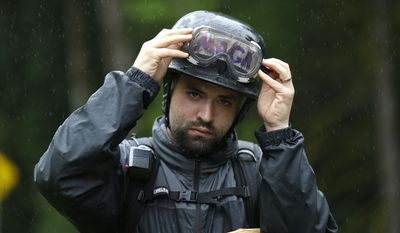 Joey Nation, a protester with the conservative group Patriot Prayer, adjusts his goggles over tape with the abbreviation of President Donald Trump&#39;s slogan &amp;quot;MAGA&amp;quot; (Make America Great Again) on his helmet as he prepares for a protest, Thursday, June 15, 2017, at Evergreen State College in Olympia, Wash. (AP Photo/Ted S. Warren)