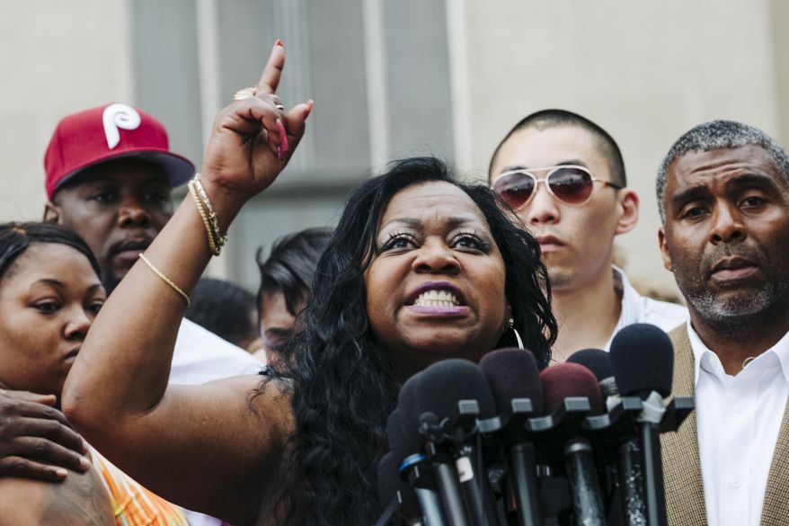 Valerie Castile, mother of Philando Castile, points to the sky during a news conference outside the Ramsey County Courthouse in St. Paul, Minn., on Friday, June 16, 2017. A Minnesota police officer was cleared Friday in the fatal shooting of Philando Castile, a black motorist whose death captured national attention when his girlfriend streamed the grim aftermath on Facebook. (Evan Frost/Minnesota Public Radio via AP)