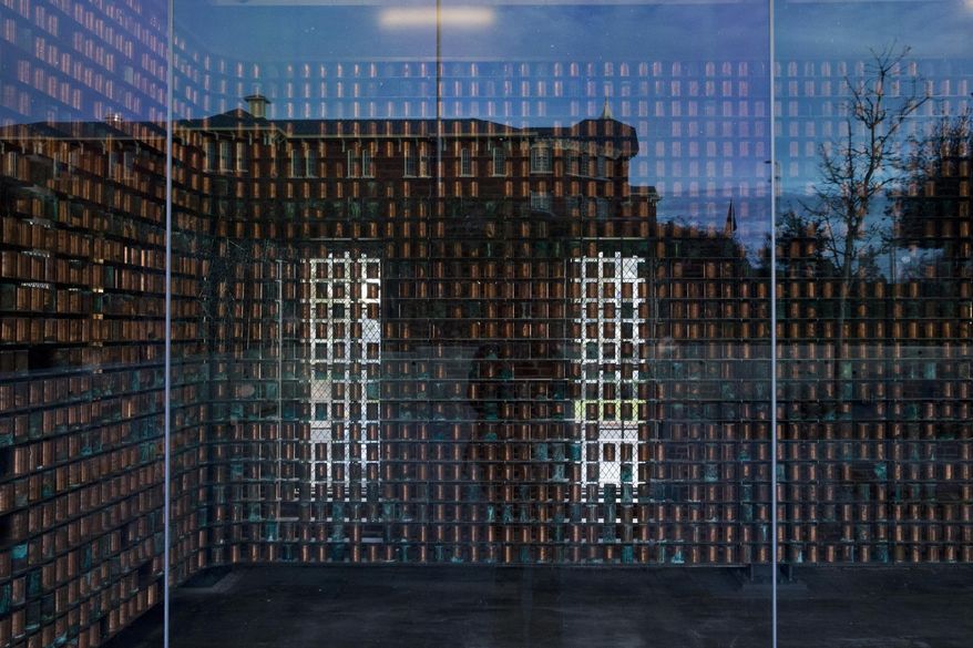 This April 11, 2016 photo shows the outdoor memorial which is steps away from the museum, and features the now empty canisters on display behind glass in the hospital's original crematorium in Salem, Ore. The cremains are embedded in a metal wall surrounding the small plaza. (Beth Nakamura/The Oregonian via AP)