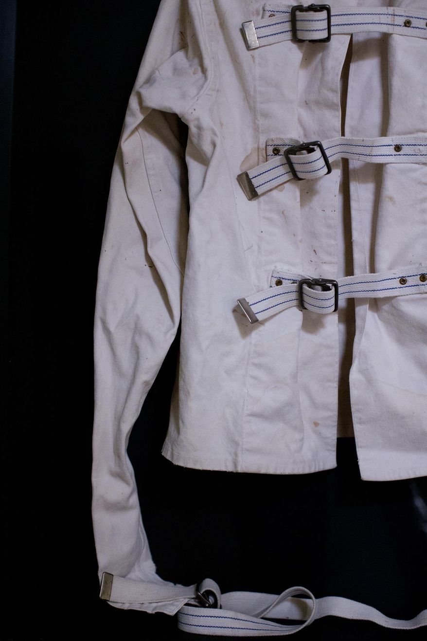 In this April 11, 2016 photo, a straightjacket, property of Oregon State Hospital, is on display at the small museum in Salem, Ore. Housed in the former entrance to the old Oregon State Hospital, the Oregon State Hospital Museum of Mental Health consists of a handful of small rooms and displays a fraction of the more than 4,000 artifacts contained in its archive. (Beth Nakamura/The Oregonian via AP)