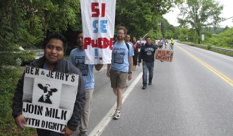 Scores of dairy farm workers and activists marching in Montpelier, Vt., on Saturday June, 17, 2017. They were marching to the main Ben &amp;amp; Jerry&#39;s factory in the Vermont town of Waterbury to protest what they feel are slow negotiations to reach a deal on their &amp;quot;Milk with Dignity&amp;quot; program that would ensure fair wages and living conditions. Ben &amp;amp; Jerry&#39;s spokesman Sean Greenwood says the company is committed to reaching a deal with workers. (AP Photo/Wilson Ring)