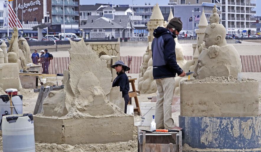 Master sand sculpting competitors work on their designs, made entirely of just sand and water, during the annual sand sculpting classic on Hampton Beach in Hampton, N.H., Friday, June 16, 2017. Artists from New England, Canada, California and Europe compete to create their designs over three days, totaling 24 hours. (AP Photo/Charles Krupa)