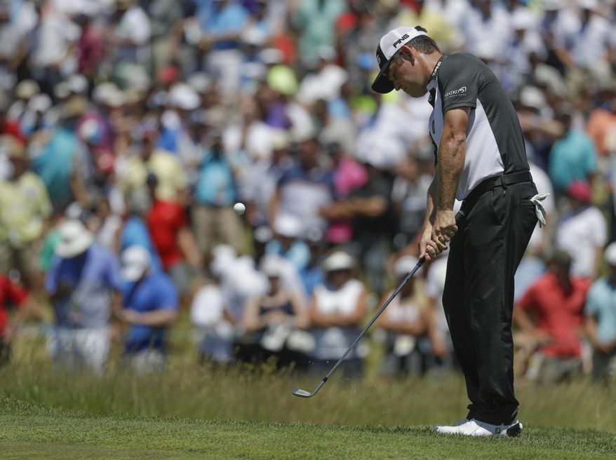 Louis Oosthuizen, of South Africa, chips to the ninth hole during the second round of the U.S. Open golf tournament Friday, June 16, 2017, at Erin Hills in Erin, Wis. (AP Photo/Chris Carlson)