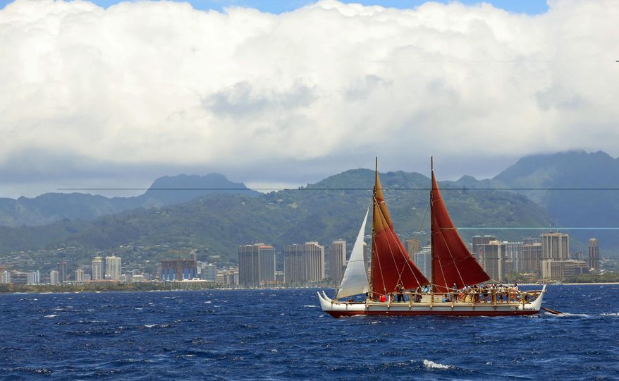 FILE - In this April 29, 2014 file photo, the Hokulea sailing canoe is seen off Honolulu. The Polynesian voyaging canoe is returning to Hawaii after a three-year journey around the world guided only by nature with navigators using no modern navigation to guide Hokulea across 40,000 nautical miles to 19 countries. Thousands are expected to welcome the double-hulled canoe to Oahu, Hawaii, on Saturday, June 17, 2017. (AP Photo/Sam Eifling, File)