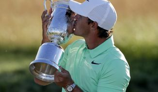 Brooks Koepka kisses the winning trophy after the U.S. Open golf tournament Sunday, June 18, 2017, at Erin Hills in Erin, Wis. (AP Photo/Chris Carlson)