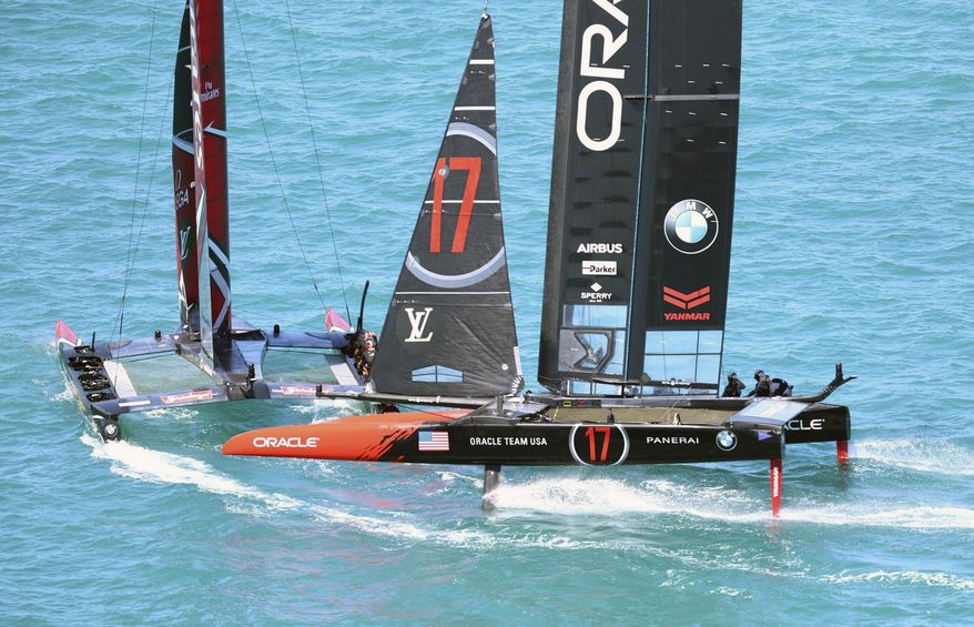 In this photo provided by the America's Cup Event Authority, Emirates Team New Zealand, left, competes with Oracle Team USA during Race 2 of the America's Cup match sailing competition, Sunday, June 18, 2017, in the Great Sound of Bermuda. (Gilles Martin-Raget/ACEA via AP)