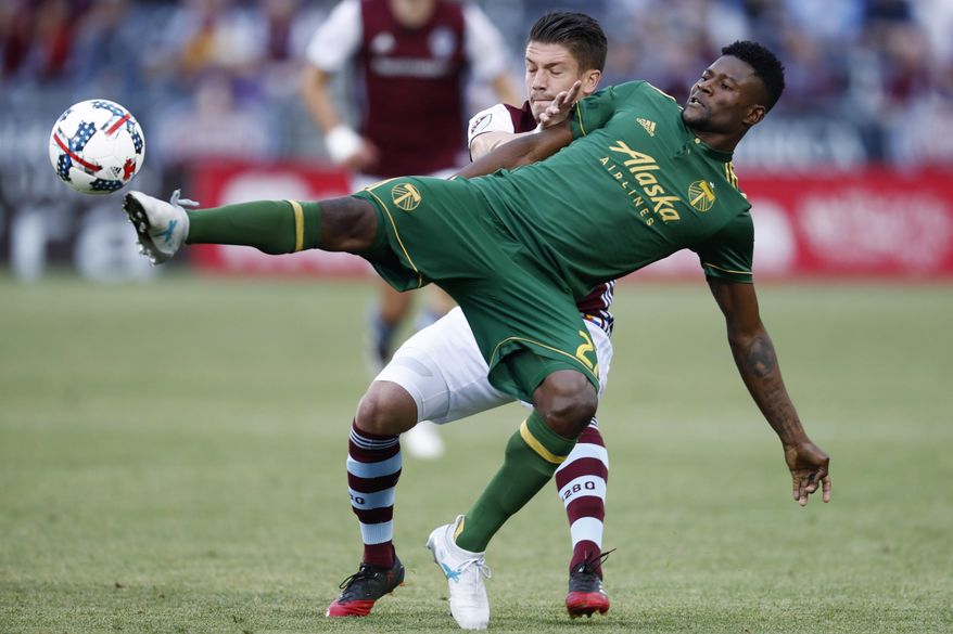 Portland Timbers forward Dairon Asprilla, front, reaches out to kick the ball as Colorado Rapids defender Mike da Fonte defends in the first half of an MLS soccer match Saturday, June 17, 2017, in Commerce City, Colo. (AP Photo/David Zalubowski)