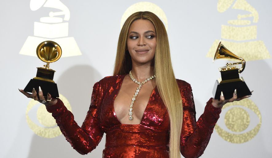 FILE - In this Sunday, Feb. 12, 2017, file photo, Beyonce poses in the press room with the awards for best music video for "Formation" and best urban contemporary album for "Lemonade" at the 59th annual Grammy Awards at the Staples Center, in Los Angeles. Several outlets have published reports that Beyonce has given birth to twins with no official confirmation and even Beyonce's father, with whom she has had a strained relationship, tweeted congrats Sunday, June 18, 2017. But there has been no word from superstars Beyonce and Jay Z themselves. (Photo by Chris Pizzello/Invision/AP, File)