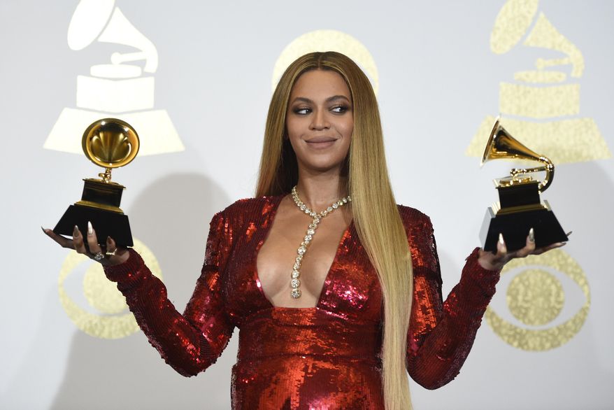 FILE - In this Sunday, Feb. 12, 2017, file photo, Beyonce poses in the press room with the awards for best music video for &amp;quot;Formation&amp;quot; and best urban contemporary album for &amp;quot;Lemonade&amp;quot; at the 59th annual Grammy Awards at the Staples Center, in Los Angeles. Several outlets have published reports that Beyonce has given birth to twins with no official confirmation and even Beyonce&#x27;s father, with whom she has had a strained relationship, tweeted congrats Sunday, June 18, 2017. But there has been no word from superstars Beyonce and Jay Z themselves. (Photo by Chris Pizzello/Invision/AP, File)
